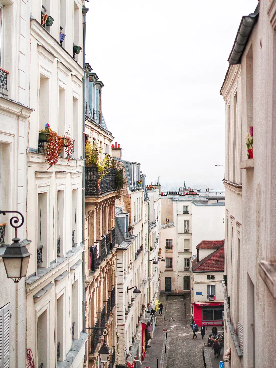 Photo d'une rue avec de beaux immeubles et la tour Eiffel au bout