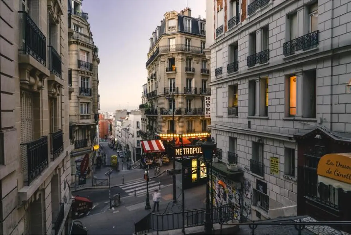 Photo d'une rue avec de beaux immeubles et la tour Eiffel au bout