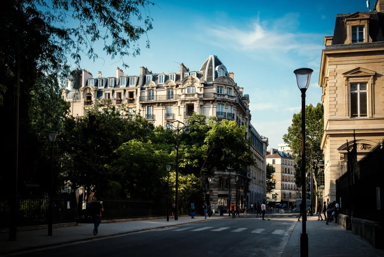 Photo d'une rue avec de beaux immeubles et la tour Eiffel au bout